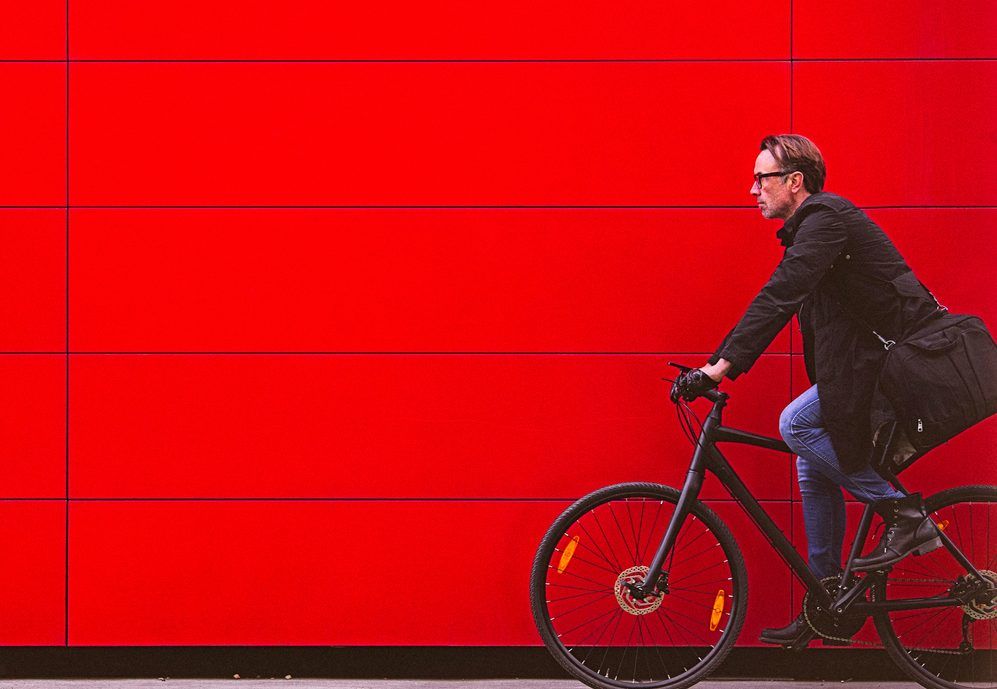 Man Cycling red wall